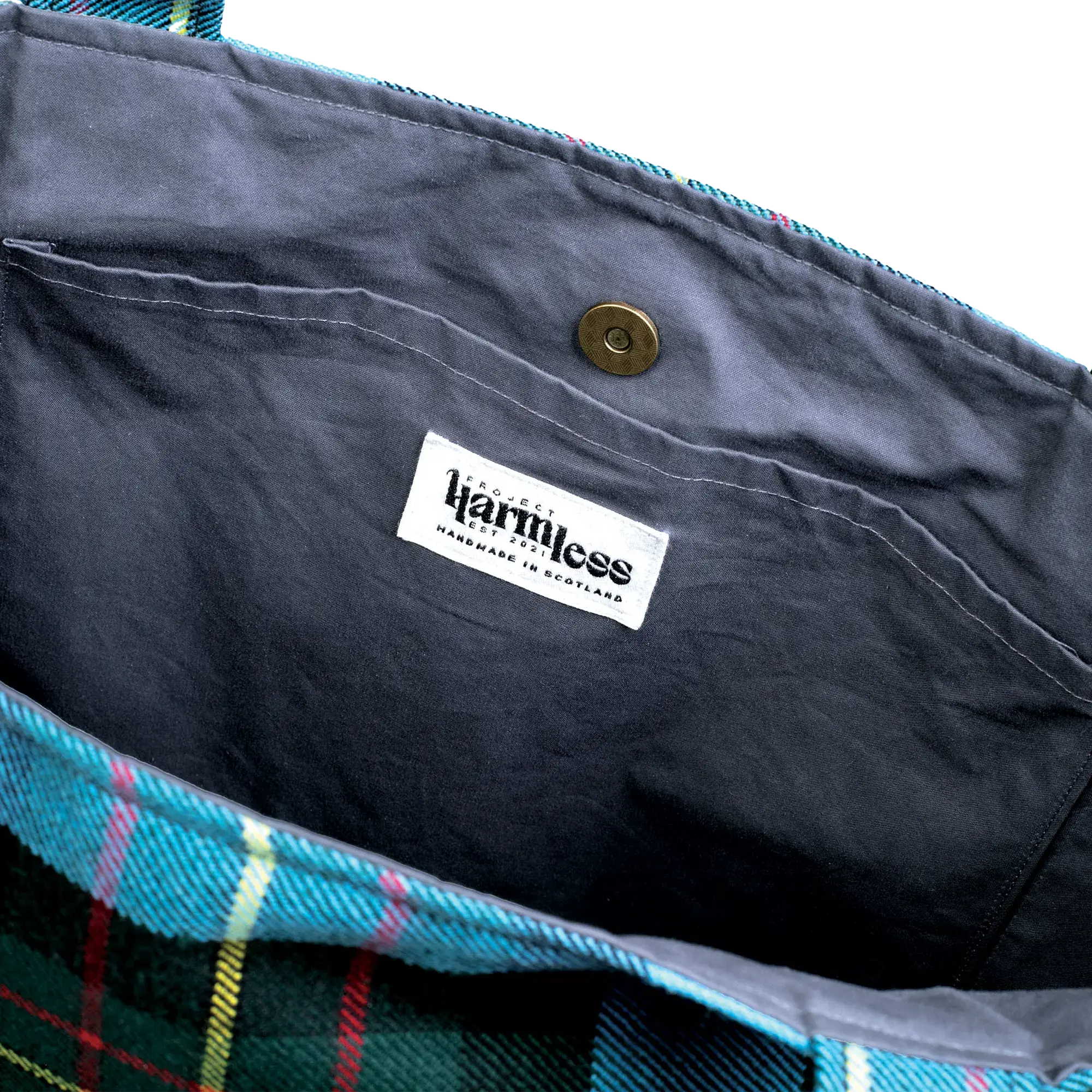 Close-up of the Harmless Atelier Oversized Carryall Bag featuring the upcycled Project Harmless leather logo patch and ‘Handmade in Scotland’ label.