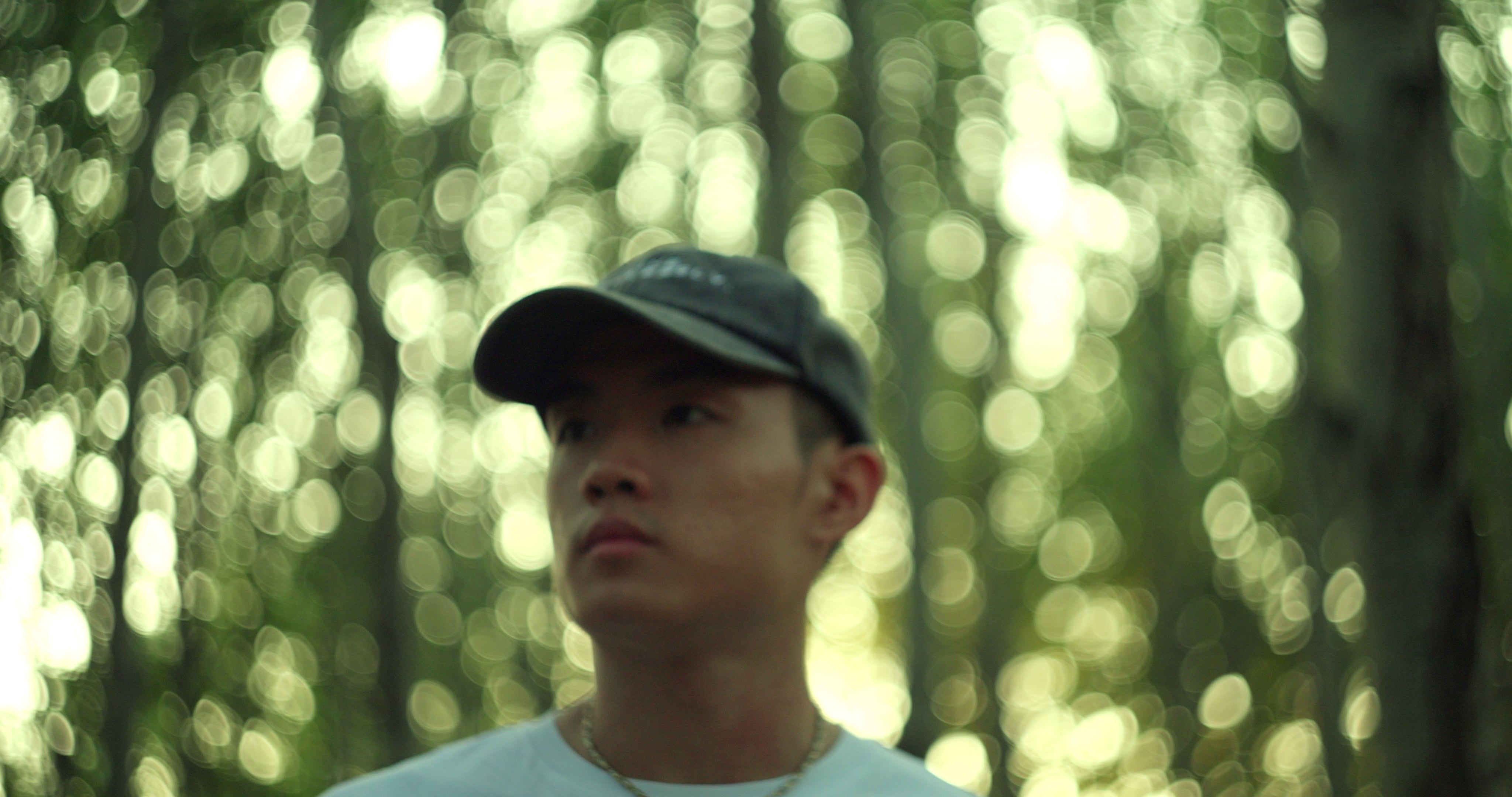 Project Harmless team member in a forest, showcasing sustainability and connection to nature, wearing eco-conscious clothing.
