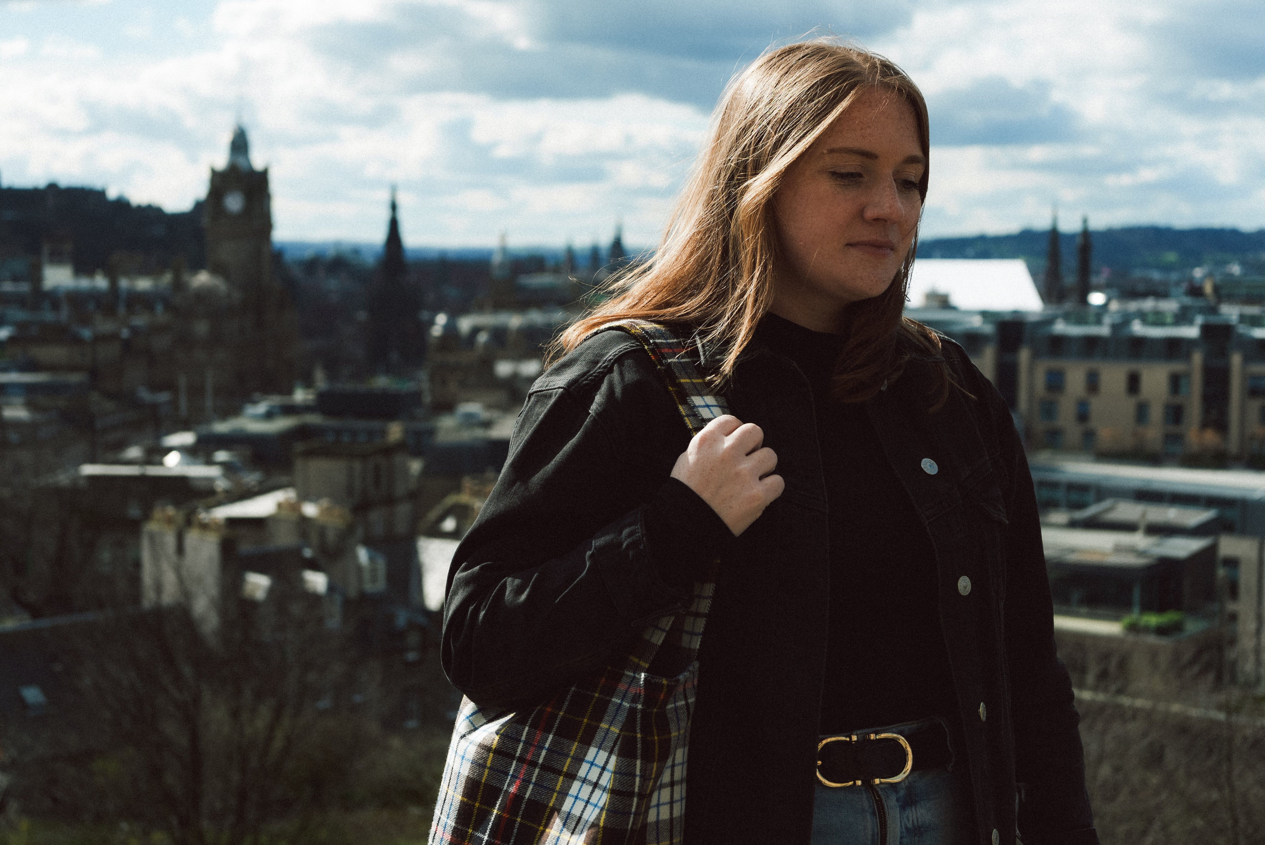Project Harmless Brand Ambassador Laura Young standing in front of Edinburgh skyline