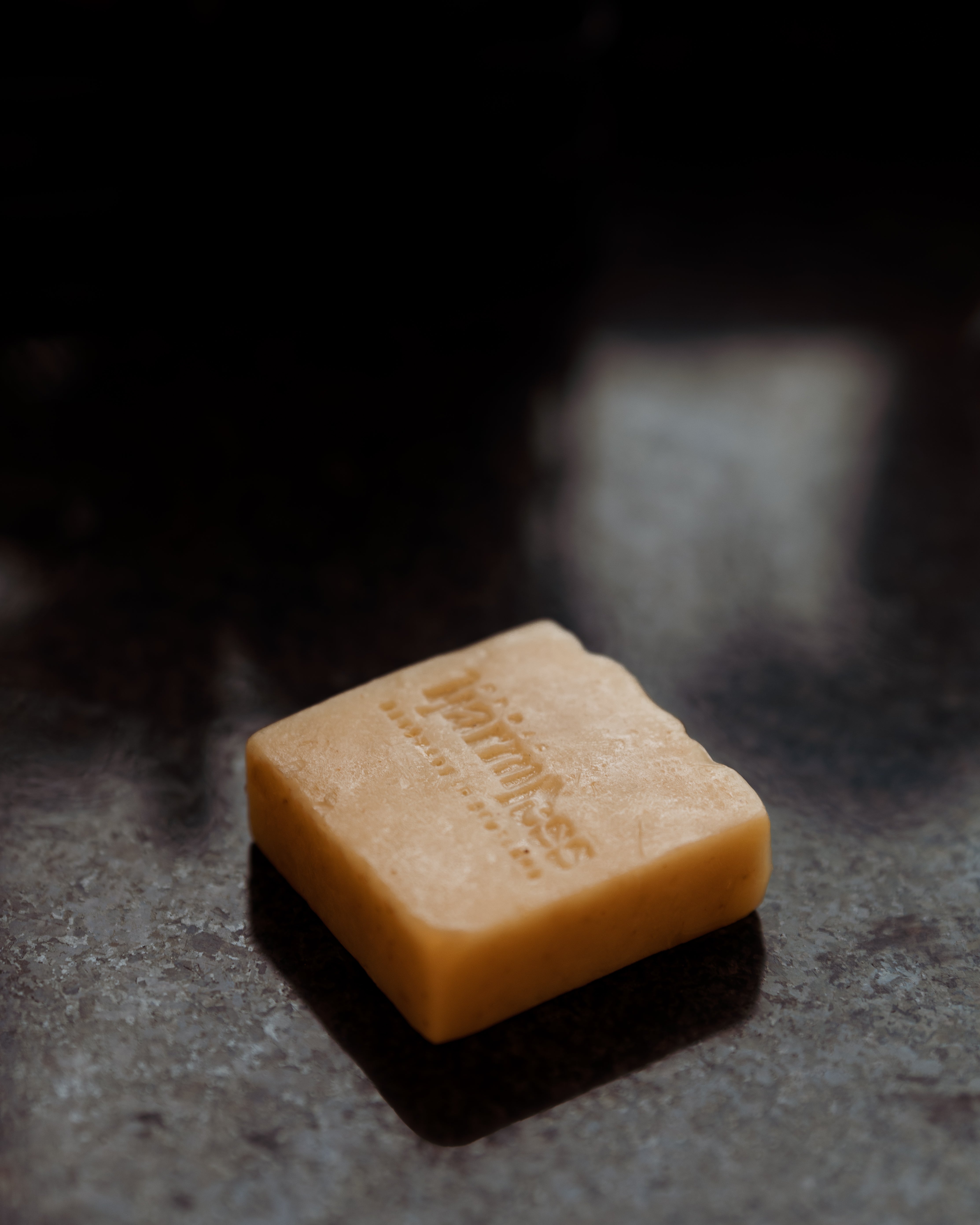 Project Harmless sustainable soap resting on a beautifully styled kitchen countertop. Handmade in Scotland using pure ingredients, this luxurious, palm oil-free soap is crafted with care for a truly indulgent experience. Featuring the soothing scent of Scottish lavender from Argyll and Bute, this eco-conscious soap embodies quality, sustainability, and heritage craftsmanship.