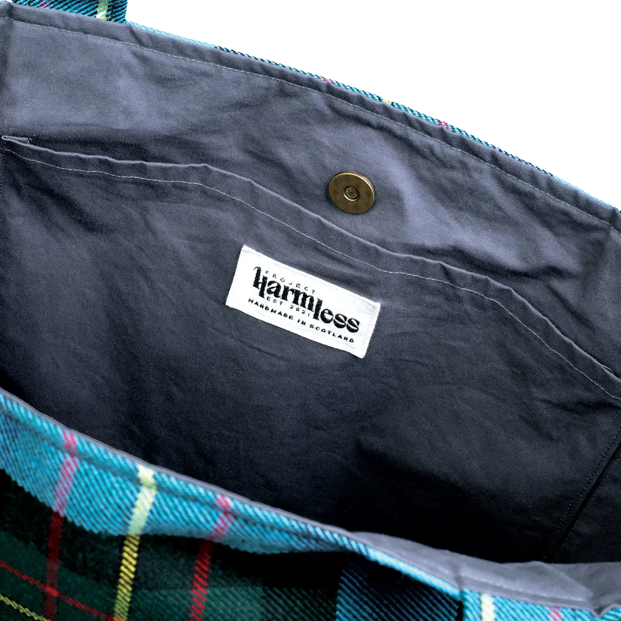 Close-up of Harmless Atelier oversized carryall upcycled leather logo patch and handmade in Scotland label