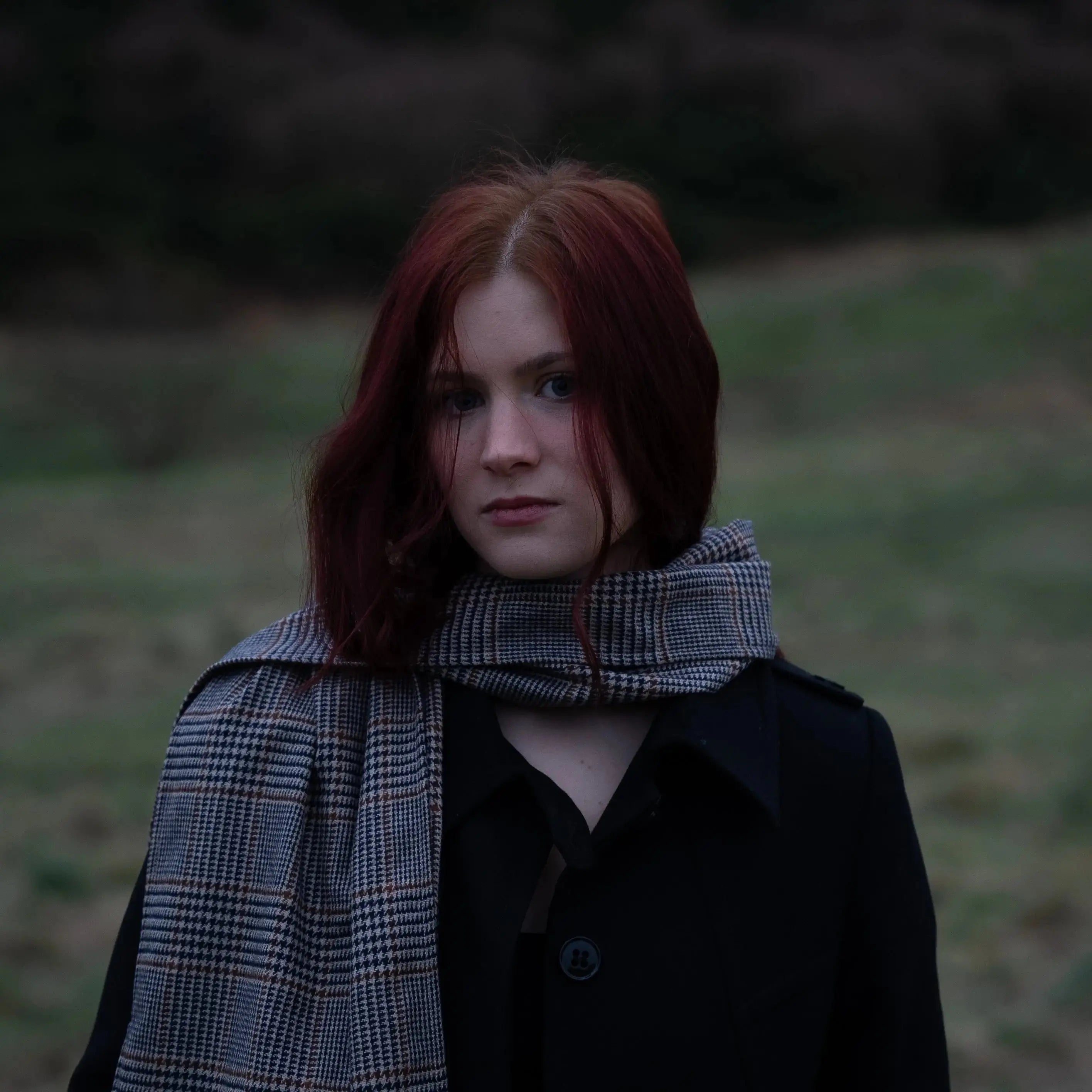 Woman wearing Harmless Atelier district check Merino wool scarf outdoors in Scotland