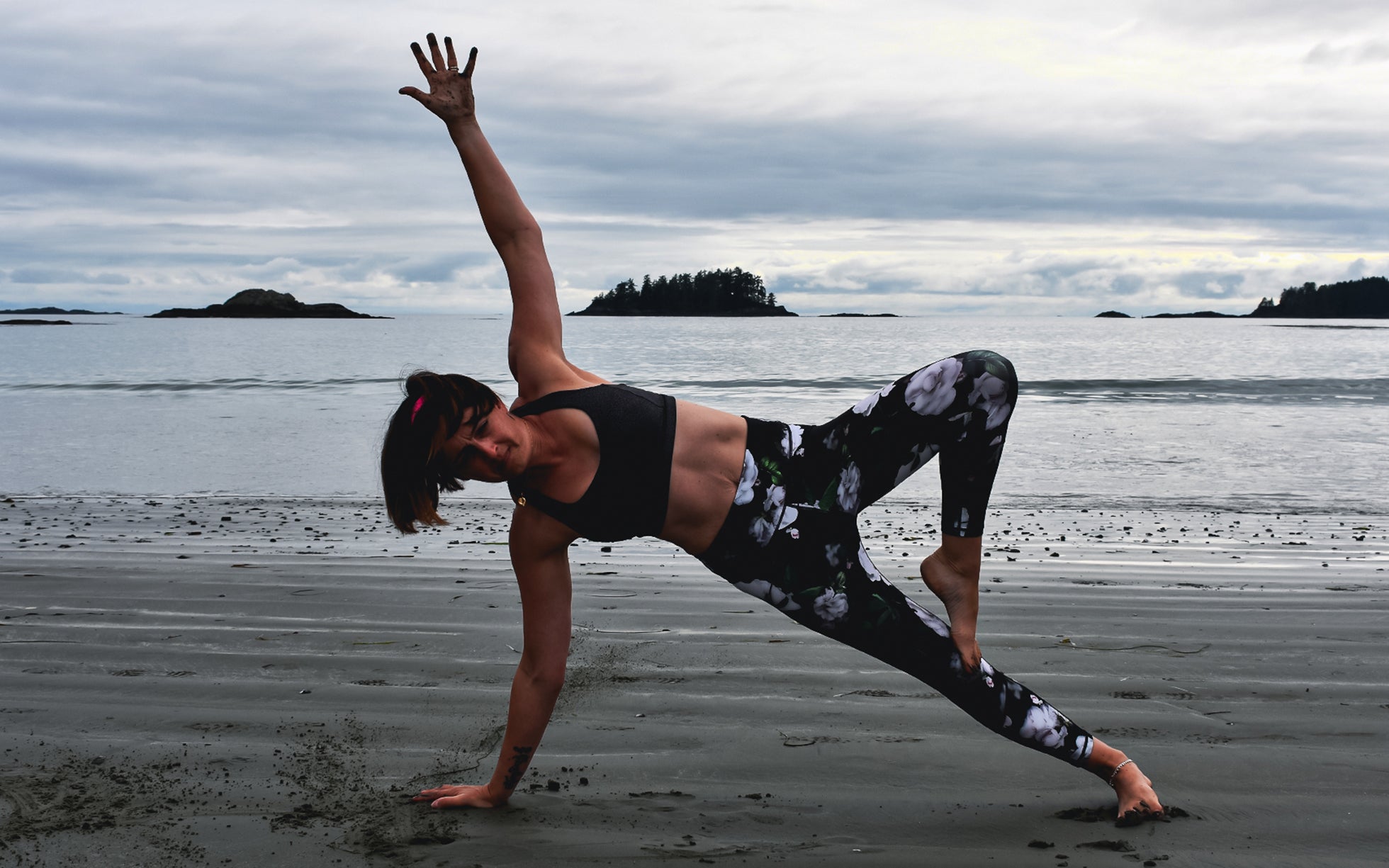 Project Harmless Community Stories - Meet Angela - Photo of Angela doing yoga on a beach in Scotland