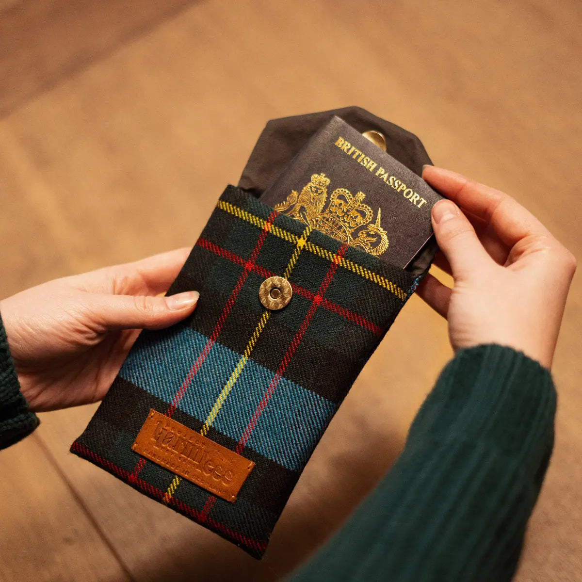 British Passport partially removed from the Harmless Atelier MacLaren Multipurpose Pouch – a handcrafted, limited-edition wool pouch with a waxed cotton lining by Project Harmless, made in Scotland.