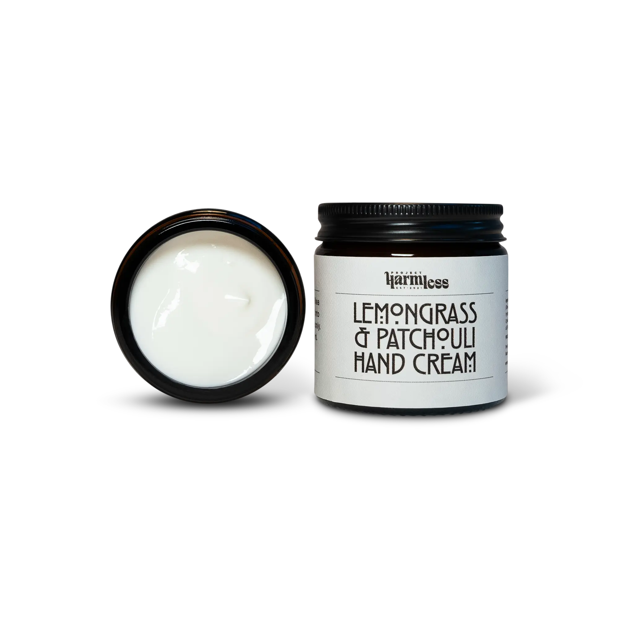 Open jar of Harmless Apothecary by Project Harmless Lemongrass & Patchouli Hand Cream, showcasing the rich, smooth texture next to the Closed jar of Harmless Apothecary by Project Harmless Lemongrass & Patchouli Hand Cream with aluminum cap, highlighting the premium design.