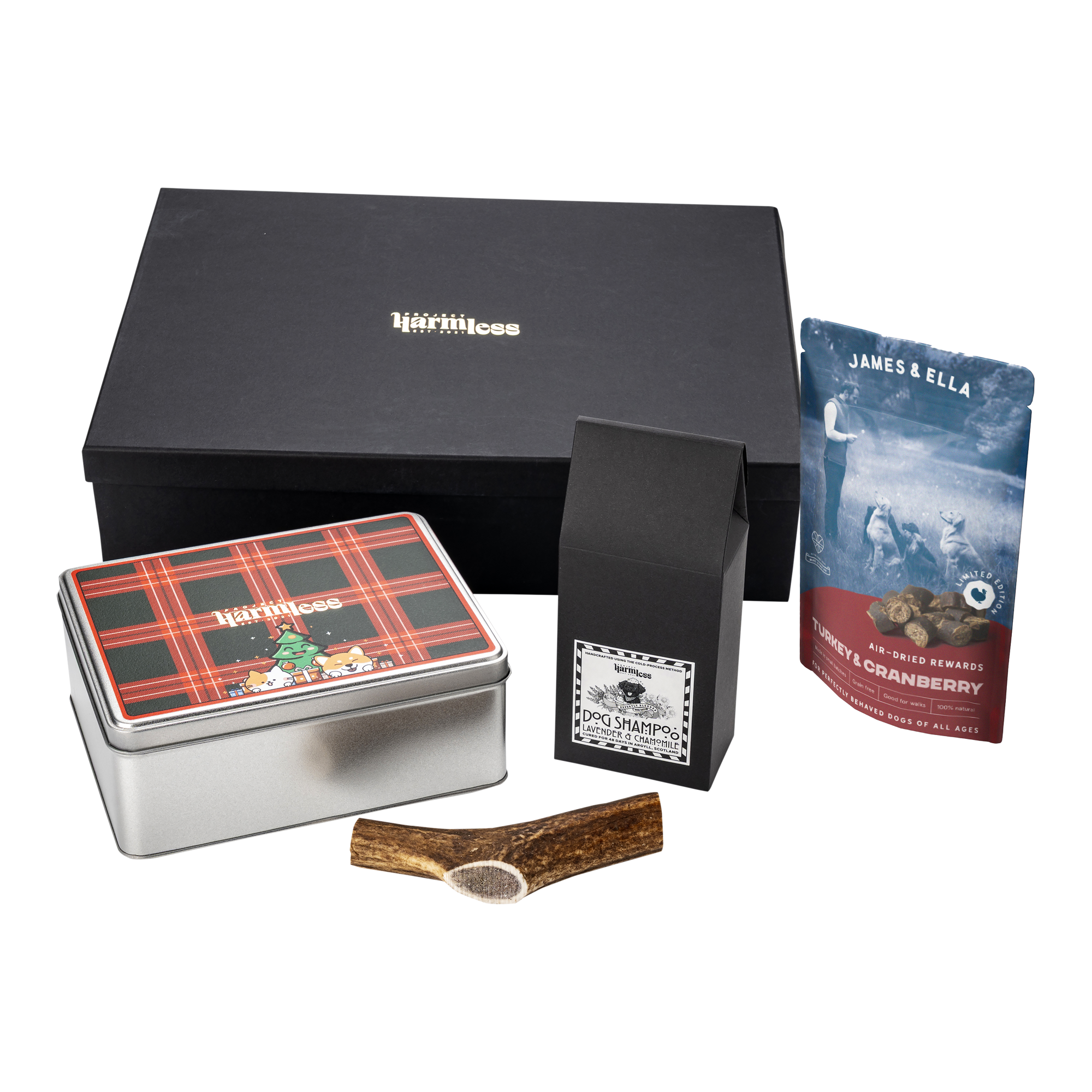 Harmless Festive Dog Gift Bundle handmade in Scotland, featuring festive sustainable poop bags, handmade dog shampoo bar, Scottish deer antler chew, and James & Ella dog treats in a luxury gift box.