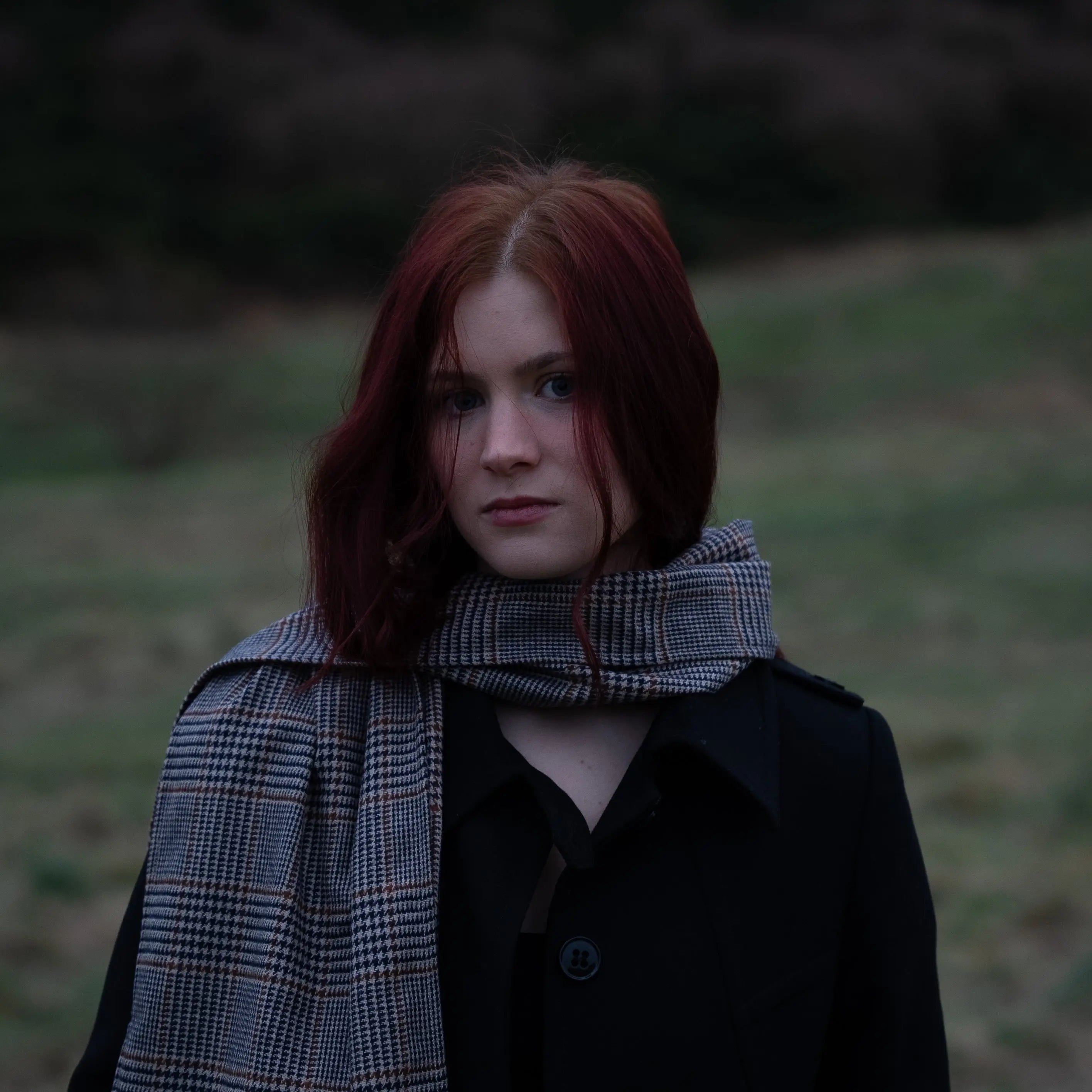 Woman wearing Harmless Atelier district check Merino wool scarf outdoors in Scotland