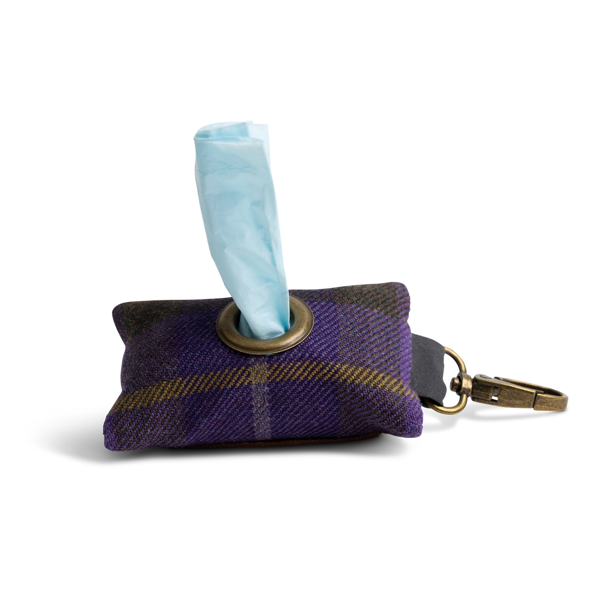 A small purple tartan Project Harmless poo bag holder, with a rolled light blue Harmless Poop Bag protruding from a metal ring, and a brass-tone clip attached. 