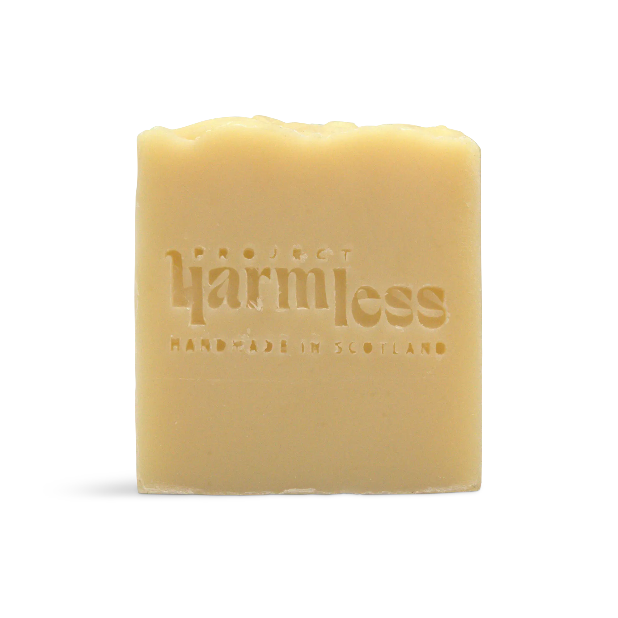 A Fireside Frankincense & Sweet Orange Soap with a Project Harmless logo, and text: "Handmade in Scotland" stamped on it.