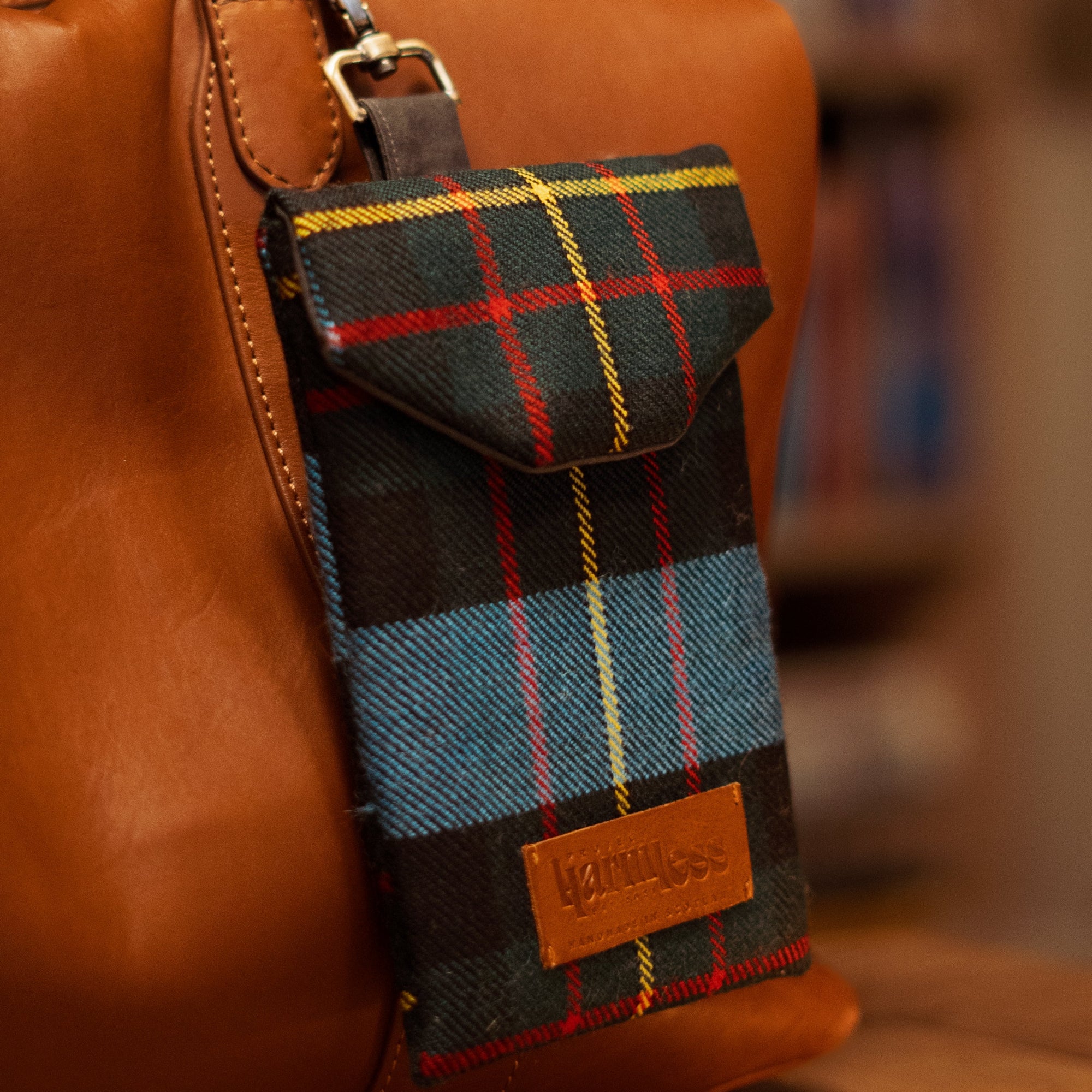 Harmless Atelier tartan travel pouch with waxed cotton lining, upcycled leather patch and magnetic closure, handmade in Scotland by Project Harmless